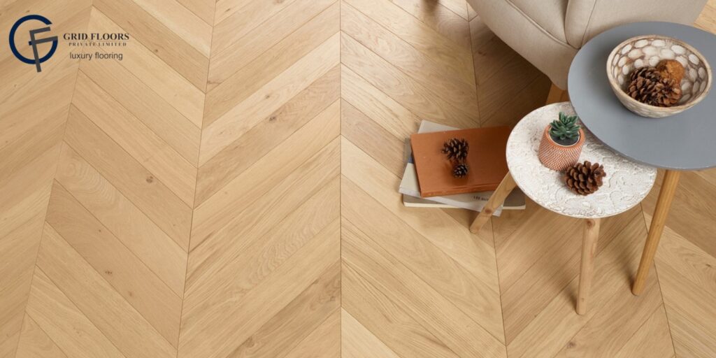 A wooden floor featuring engineered hardwood, complemented by a table and a chair, creating a cozy interior setting